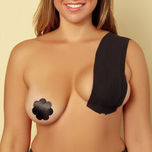 Load image into Gallery viewer, A woman using The Boob Tape and black nipple covers.
